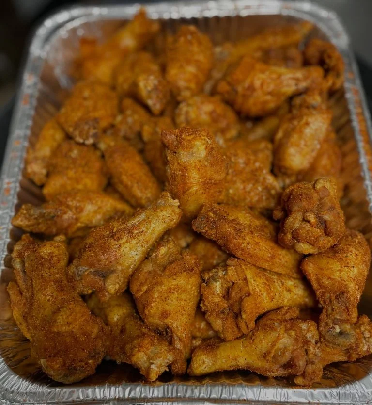 A full catering tray of golden Rooster's wings