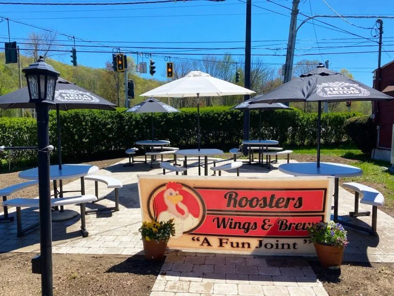 Rooster's storefront and outdoor patio tables in Mohegan Lake