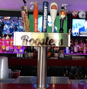Draft beer taps above the Rooster's sign at the bar.
