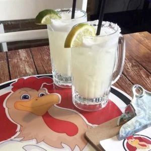 Two margaritas with salted rims and citrus garnishes at Rooster's Wings & Brew.