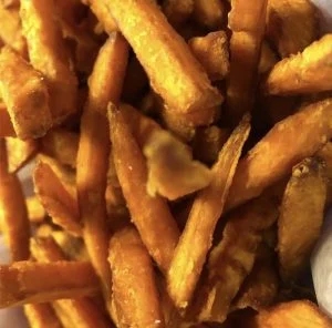 Close-up of golden sweet potato fries.
