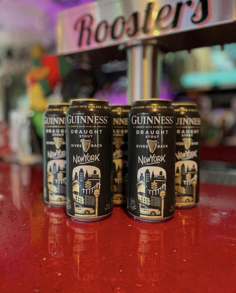 Guinness cans on the bar beneath the Rooster's sign in Mohegan Lake, NY.