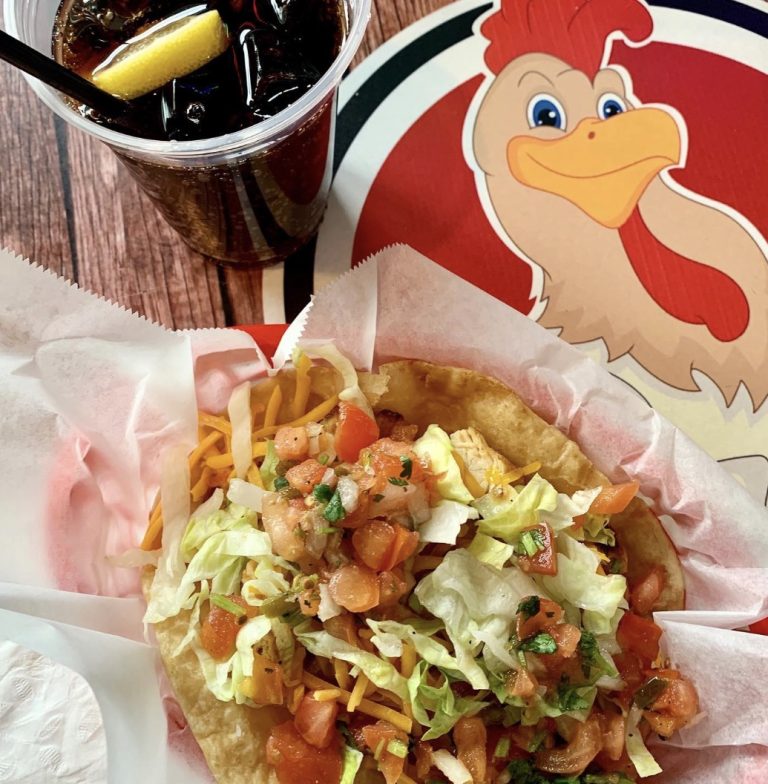 Taco topped with shredded lettuce, cheese and pico de gallo beside the Rooster's logo.
