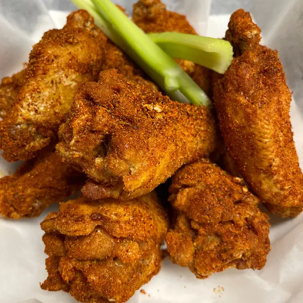 Cajun traditional wings with celery at Roosters