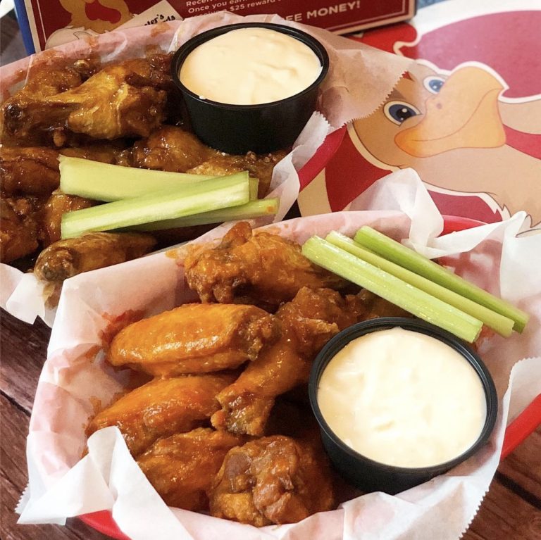 Two baskets of Rooster's sauced wings with celery and dip